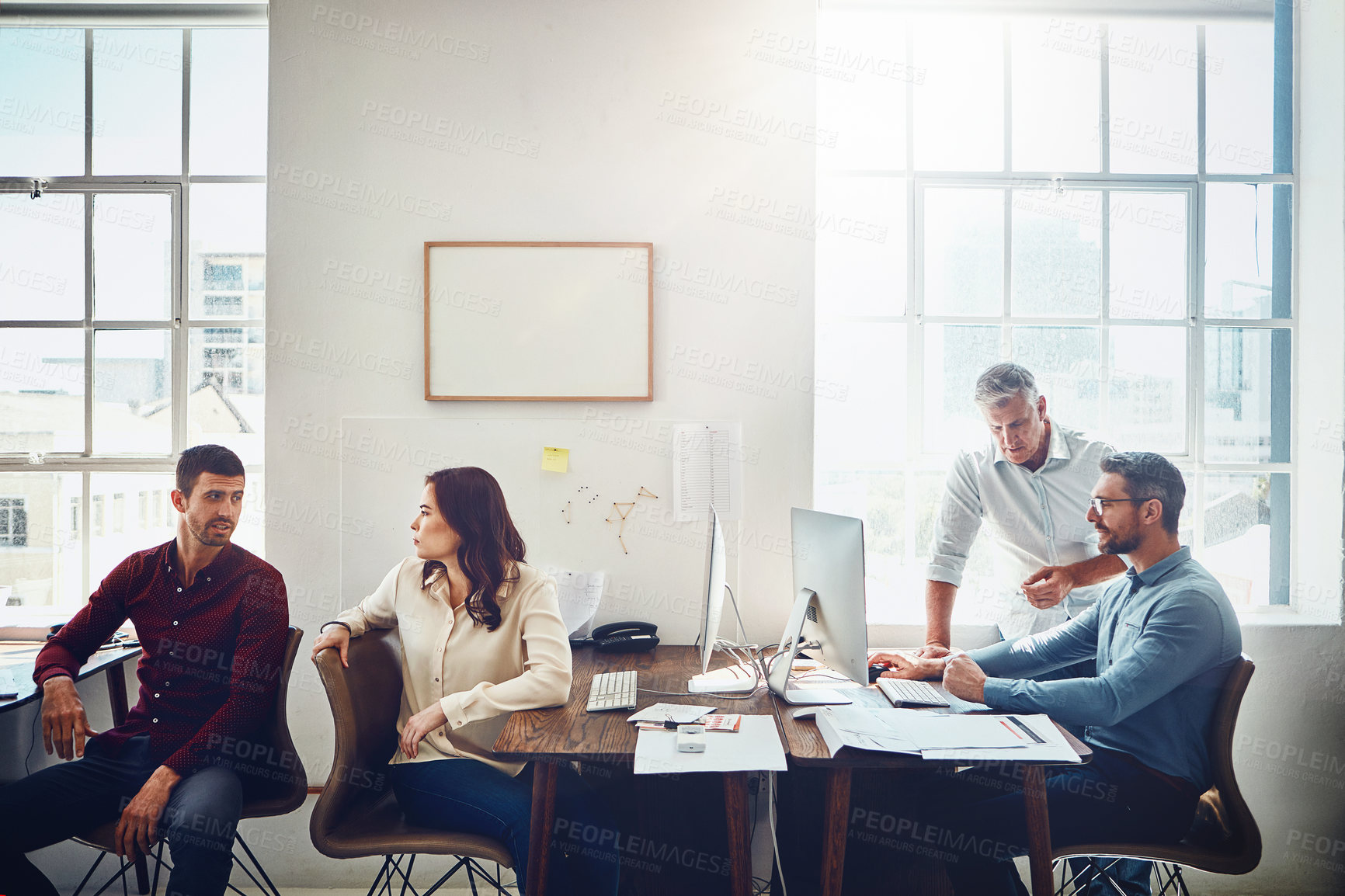 Buy stock photo Cropped shot of a group of colleagues working in their creative office