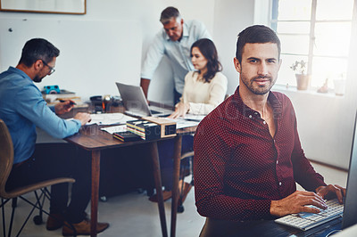 Buy stock photo Portrait of a young man working in the office with his colleagues in the background