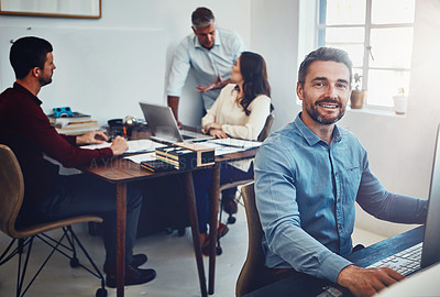 Buy stock photo Portrait of a mature man working in the office with his colleagues in the background