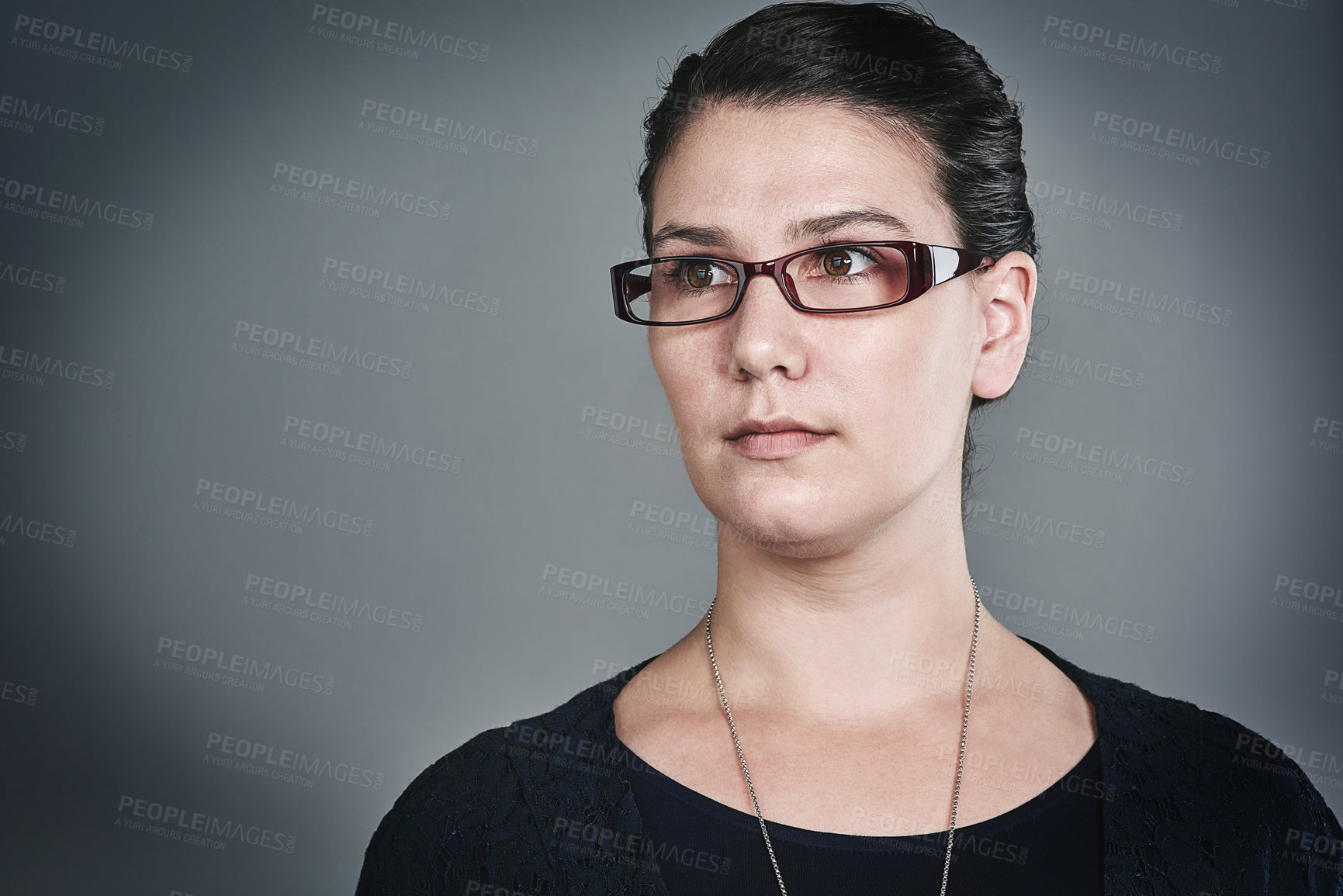 Buy stock photo Studio shot of a confident young businesswoman posing against a grey background