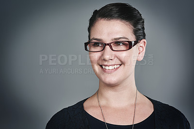 Buy stock photo Studio shot of a happy young businesswoman posing against a grey background