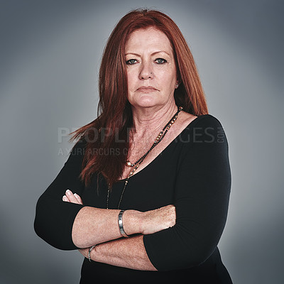 Buy stock photo Studio portrait of a confident mature businesswoman posing against a grey background