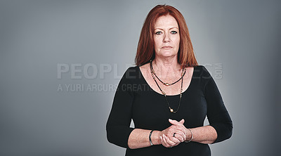 Buy stock photo Studio portrait of a confident mature businesswoman posing against a grey background