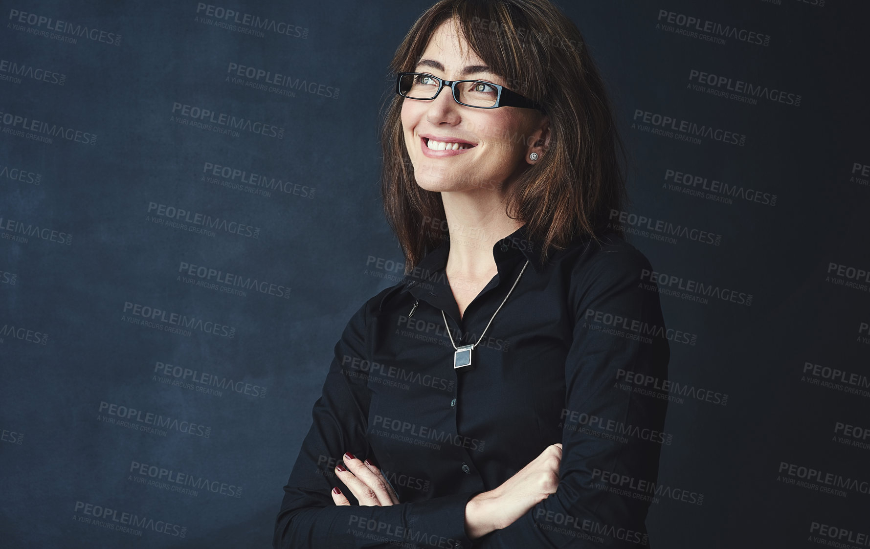 Buy stock photo Studio shot of a corporate businesswoman looking thoughtful against a dark background