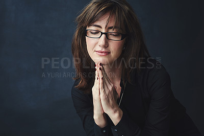 Buy stock photo Studio shot of a corporate businesswoman posing against a dark background