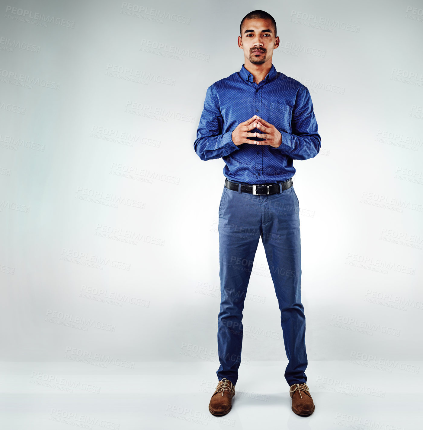 Buy stock photo Shot of a young businessman posing against a grey background