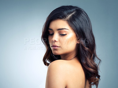 Buy stock photo Studio shot of a beautiful young woman posing against a gray background