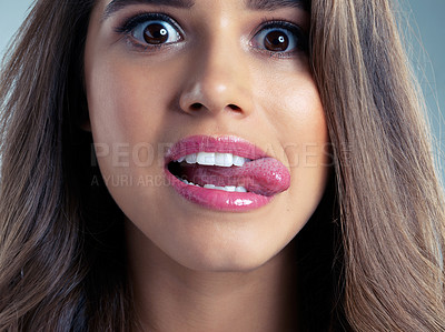 Buy stock photo Beauty, funny face and tongue out with portrait of woman on studio blue background for aesthetic wellness. Comedy, cosmetics or humor and face of silly model with playful expression for dermatology
