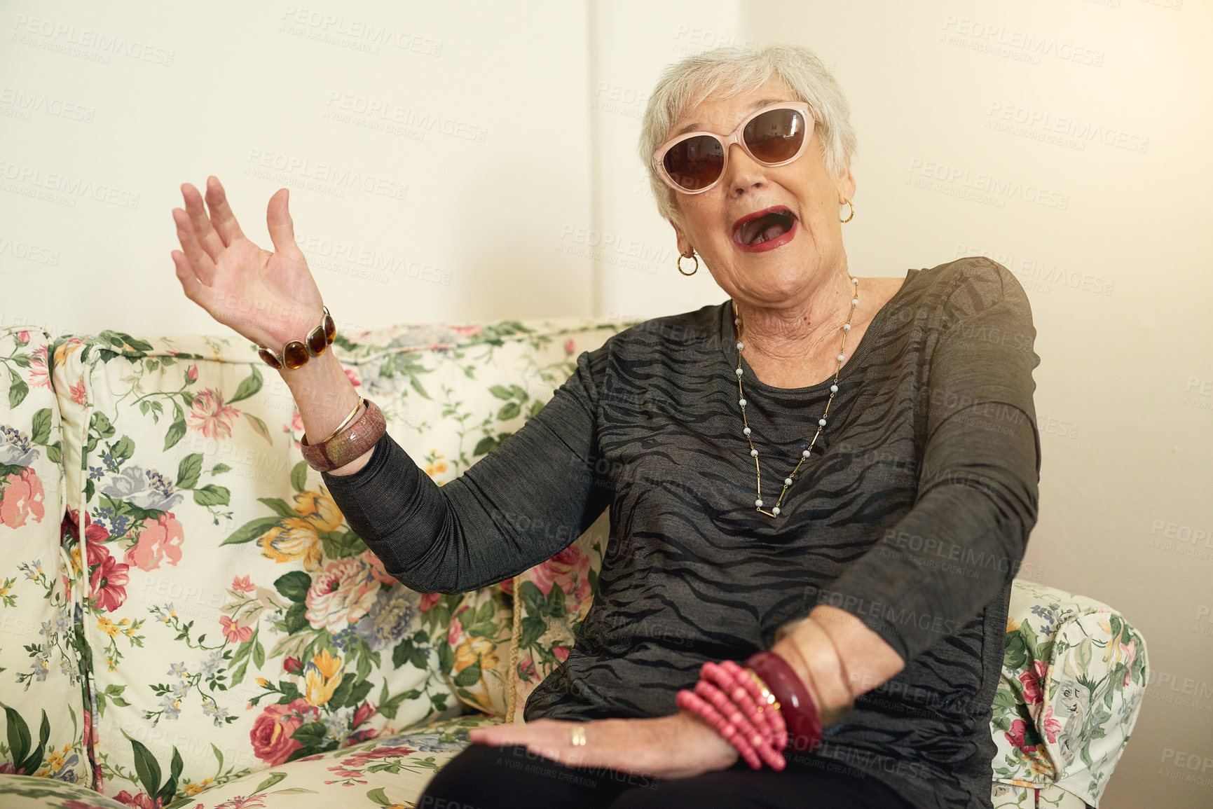 Buy stock photo Portrait, elderly woman with sunglasses for fun, retirement and crazy or silly expression on sofa. Cool person, senior lady and comic face on couch for comedy joke with funny meme and goofy happiness