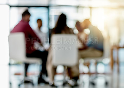 Buy stock photo Bokeh shot of a group of designers sitting in a meeting in their office