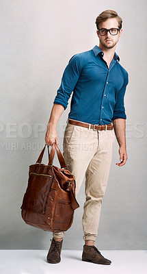 Buy stock photo Full length portrait of a handsome young man posing with a bag in the studio