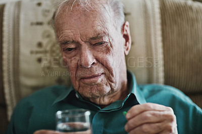 Buy stock photo Cropped shot of a senior man about to take his medication
