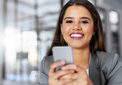 Buy stock photo Portrait of a young businesswoman texting on a cellphone in an office