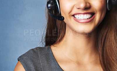 Buy stock photo Studio shot of a professional young woman wearing a headset against a gray background