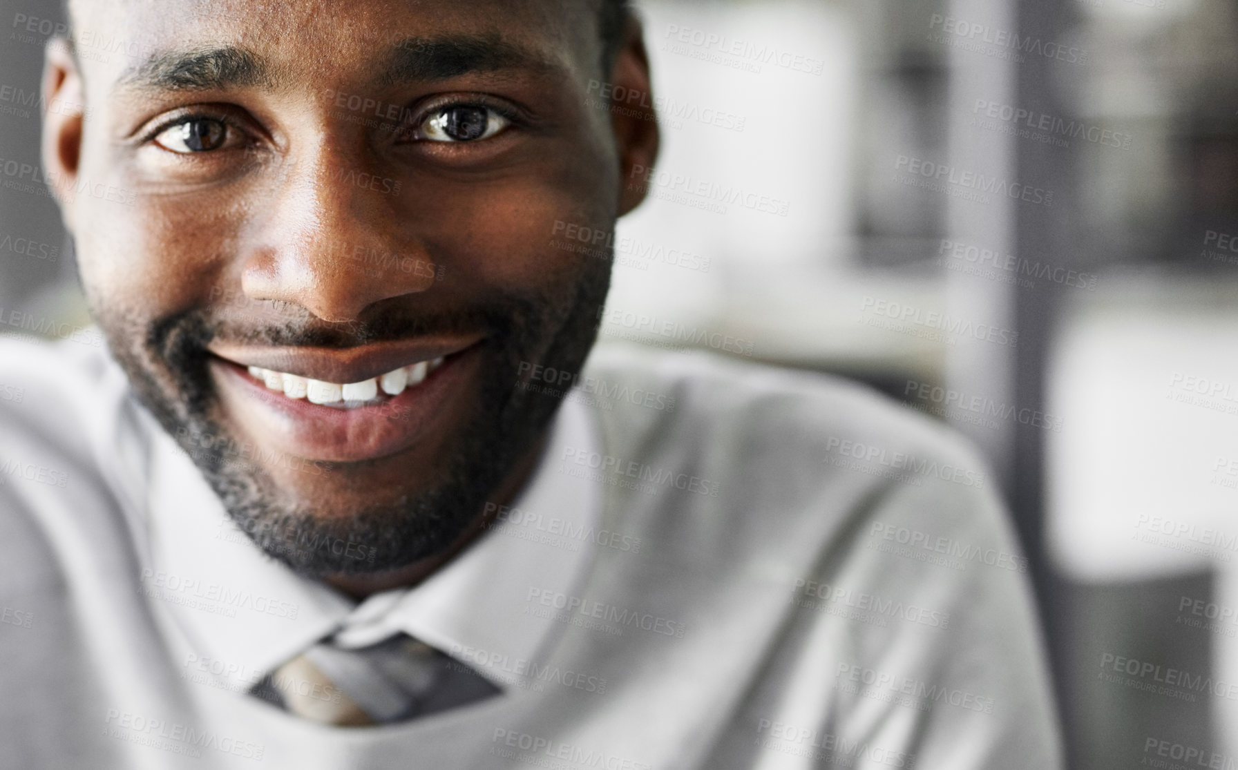 Buy stock photo Portrait of a smiling young businessman sitting at a desk in an office