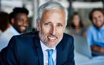 Buy stock photo Portrait of a mature businessman having a meeting with his colleagues at work