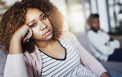 Buy stock photo Portrait of a young woman looking despondent after having a fight with her boyfriend at home