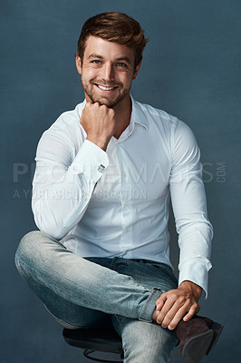 Buy stock photo Studio portrait of a handsome young man posing against a dark background