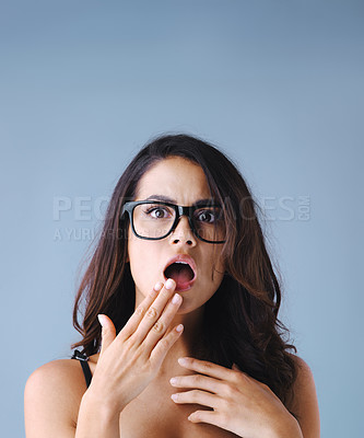 Buy stock photo Studio shot of an attractive young woman looking shocked against a gray background