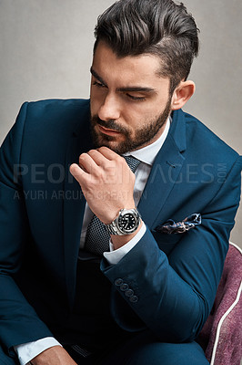 Buy stock photo Studio shot of a young businessman looking thoughtful against a grey background