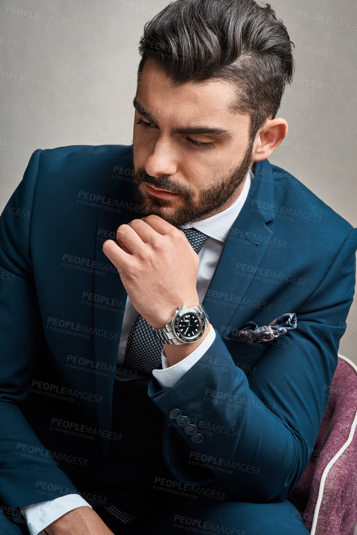 Buy stock photo Studio shot of a young businessman looking thoughtful against a grey background