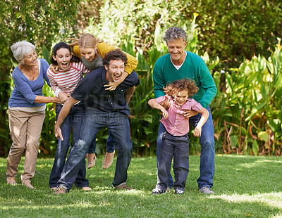 Buy stock photo Family, freedom and playing in outdoor nature, love and bonding together or happy in backyard. Generations, smile and laugh or game for humor in garden or park, vacation and summer holiday in France