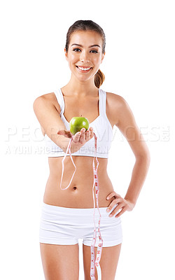 Buy stock photo Portrait of a healthy young woman holding an apple and a measuring tape