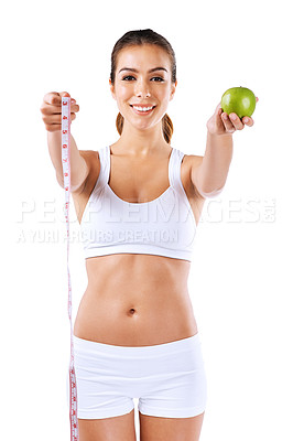 Buy stock photo Portrait of a healthy young woman holding an apple and a measuring tape