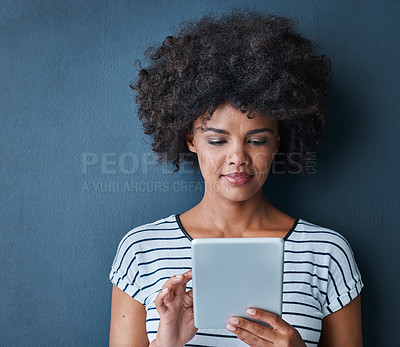 Buy stock photo African woman, tablet and scroll in studio for reading, thinking or study on app for test by blue background. Person, girl and student on digital touchscreen, online course or elearning for education