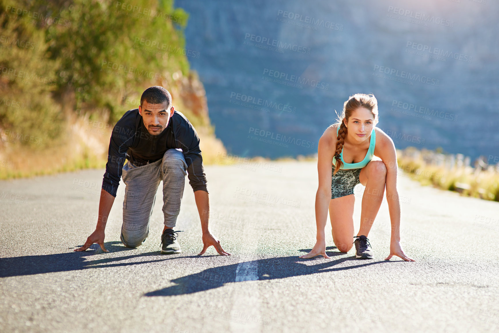 Buy stock photo Fitness, man and woman on road to start race, exercise marathon training together in mountain. Ready, challenge and runner with personal trainer, outdoor workout and running competition on asphalt.