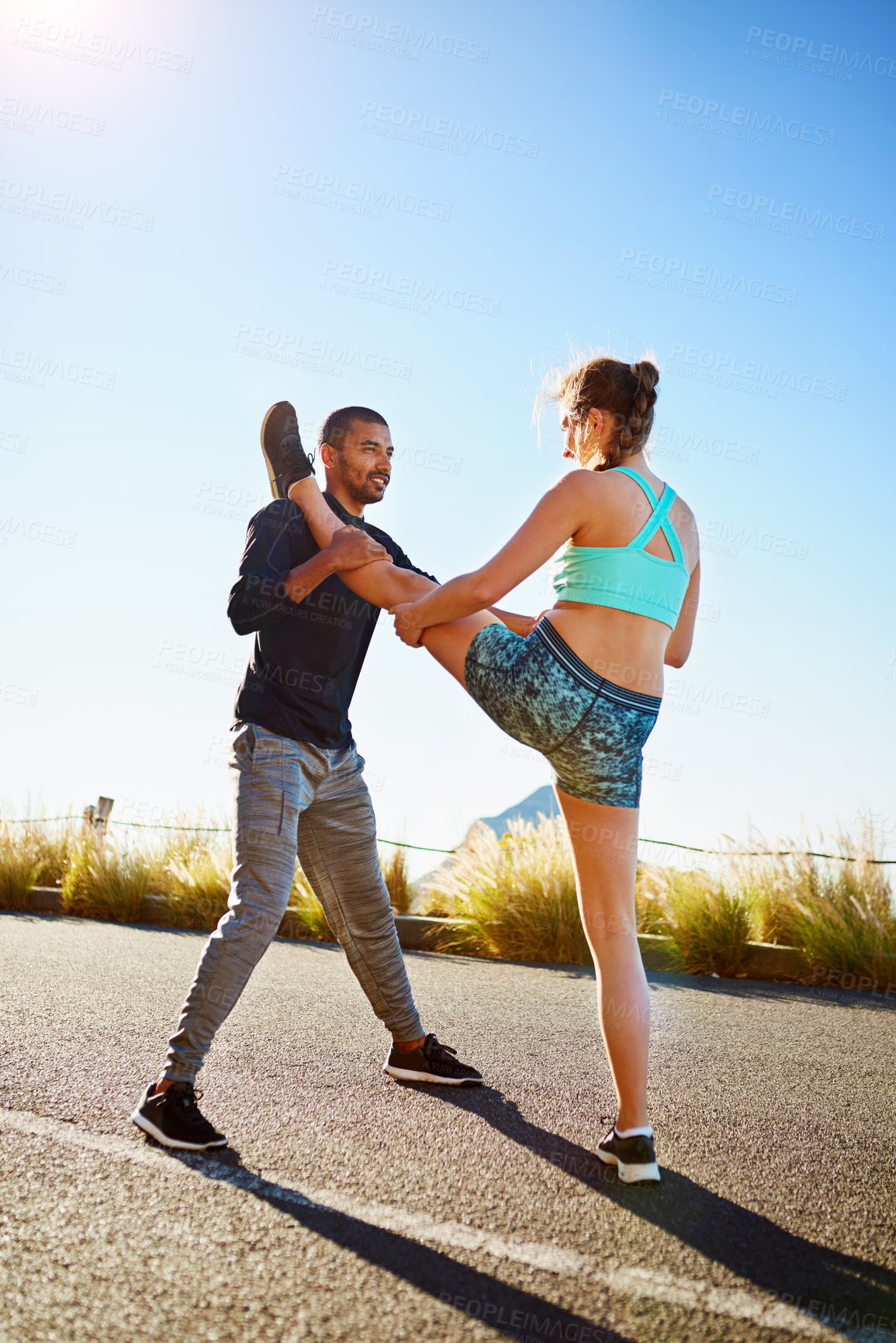 Buy stock photo Fitness, man and woman on mountain stretching legs with support, coaching and morning body training together. Warm up, athlete girl and personal trainer in nature for help with outdoor muscle workout