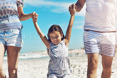 Buy stock photo Cropped shot of a happy young family enjoying their day at the beach