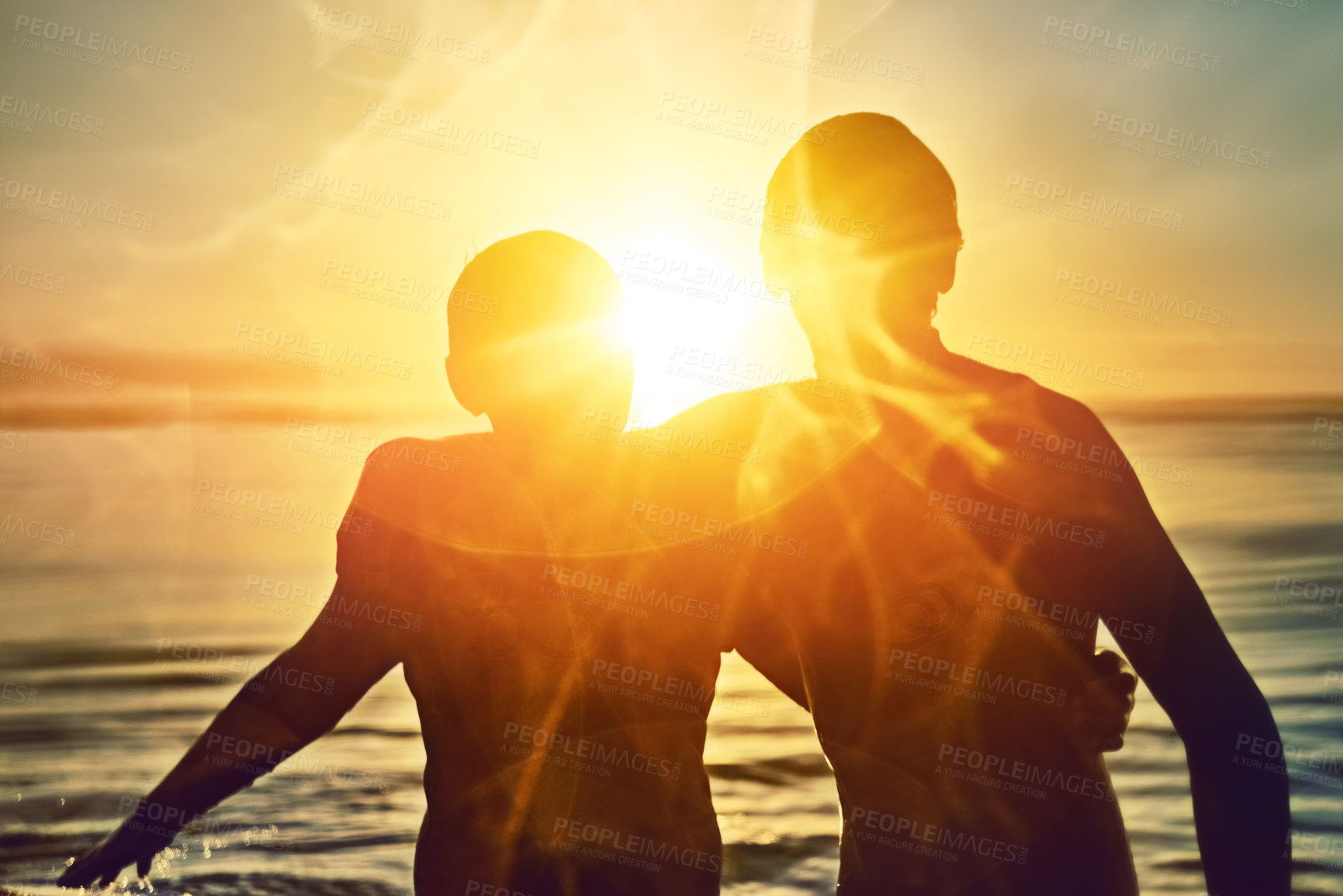 Buy stock photo Silhouette, sunshine or friends hug at sea for fitness training, workout or sports exercise in water or Hawaii. Lens flare, sunset or surfers ready to start surfing on fun holiday vacation at beach