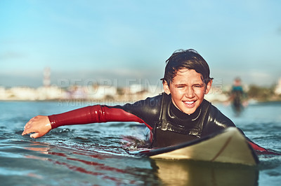 Buy stock photo Shot of a young boy out surfing
