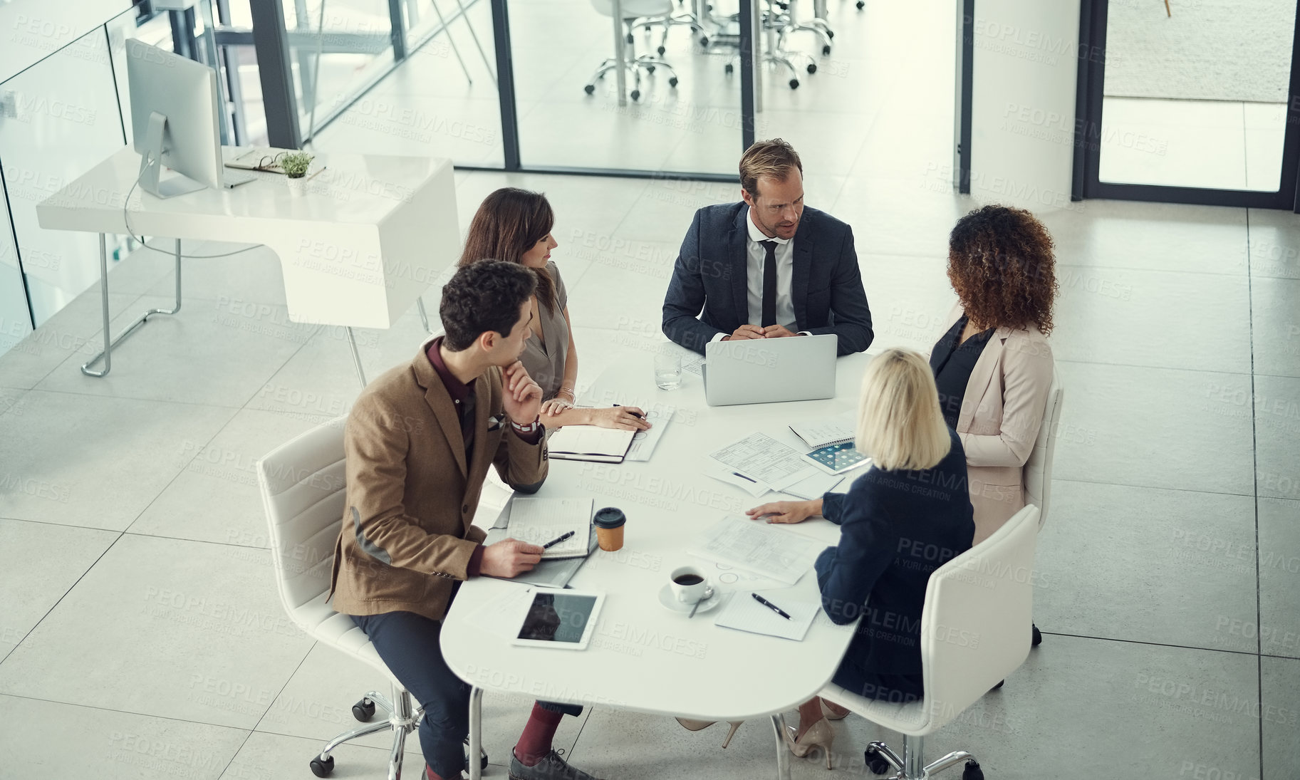 Buy stock photo Shot of a team of colleagues having a meeting in a modern office