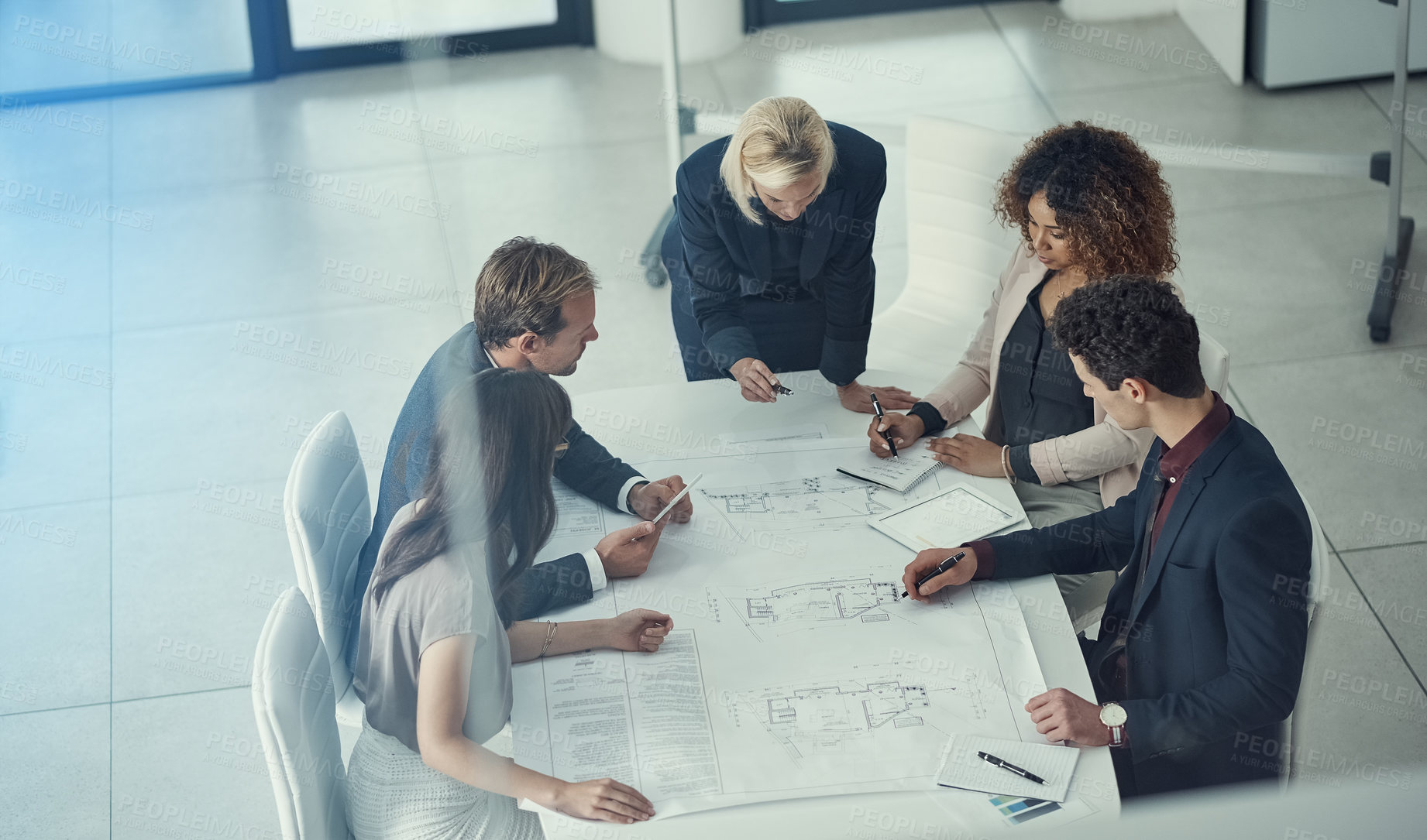 Buy stock photo Shot of a team of corporate architects collaborating on a plan in a modern office