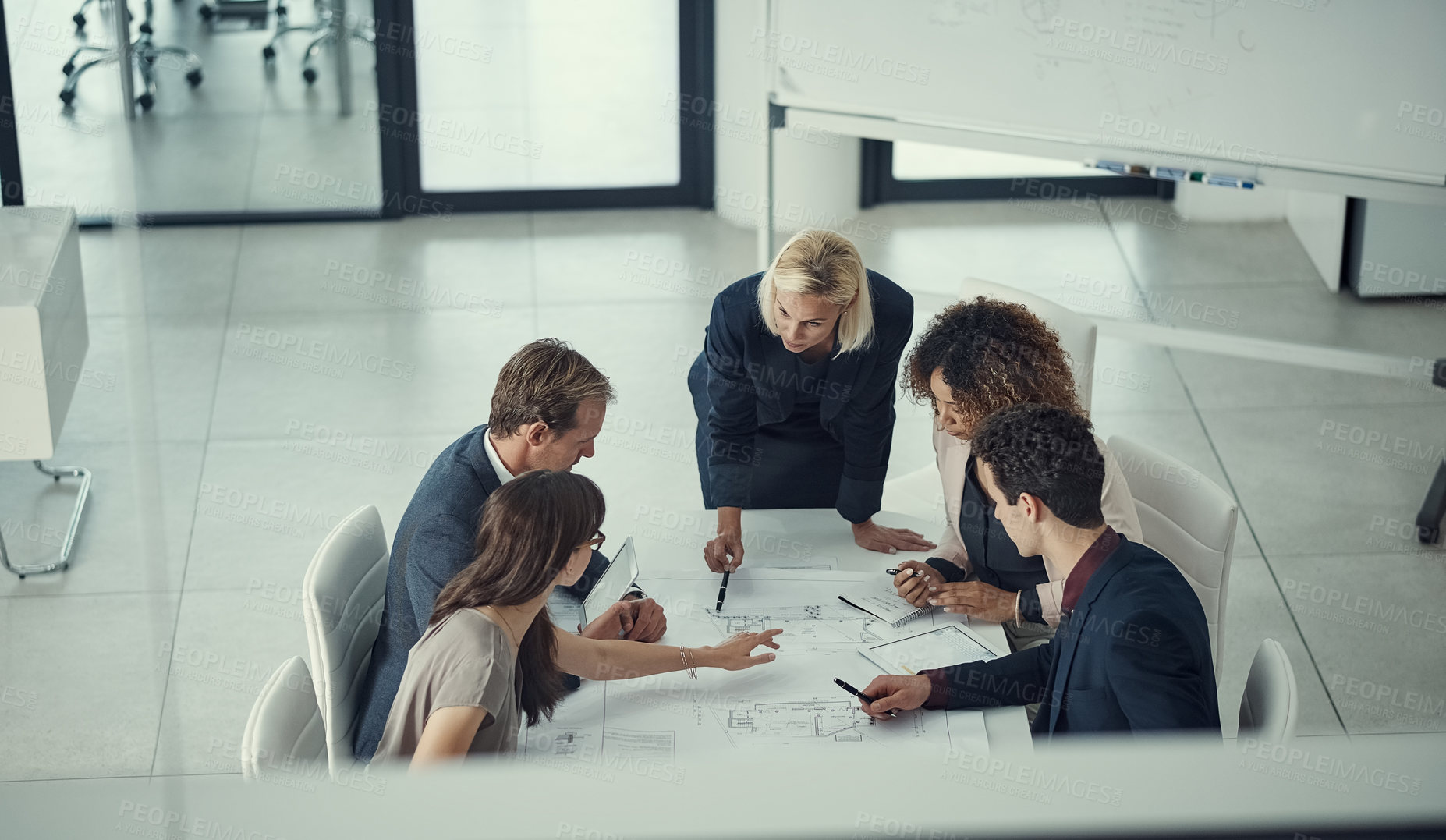 Buy stock photo Shot of a team of corporate architects collaborating on a plan in a modern office