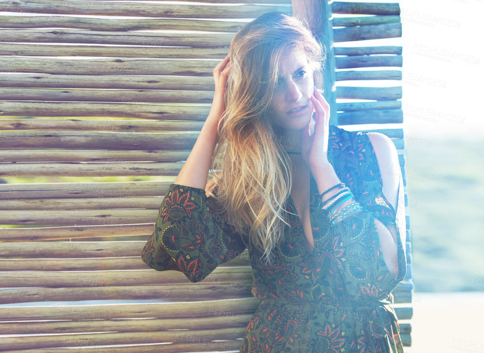 Buy stock photo Cropped shot of a fashionable young woman posing against a wooden partition