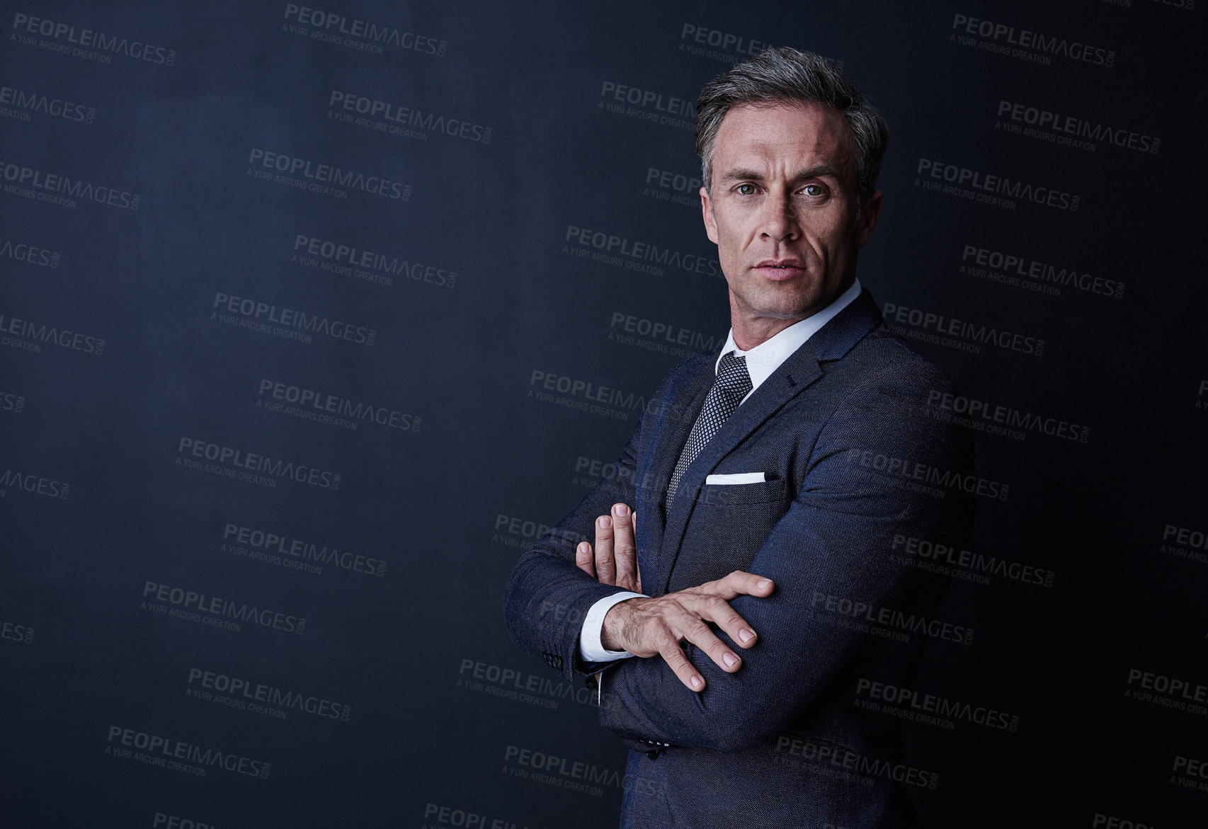 Buy stock photo Studio portrait of a confident and mature businessman standing against a dark background