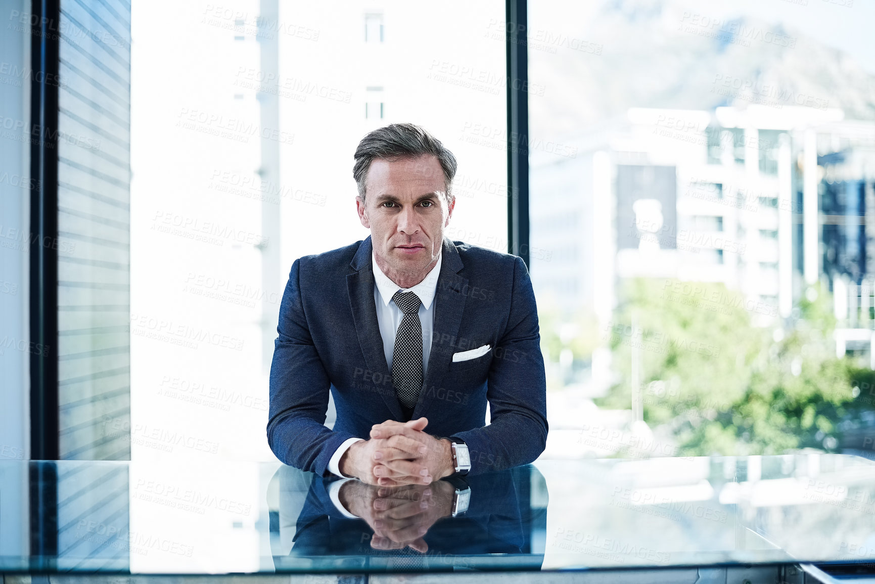 Buy stock photo portrait of a successful businessman sitting at his desk in an office