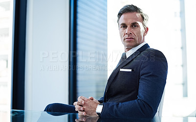 Buy stock photo portrait of a successful businessman sitting at his desk in an office