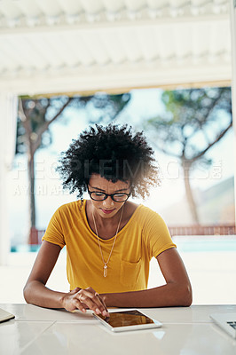 Buy stock photo Cropped shot of an attractive young woman using her laptop while chilling at home