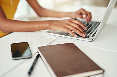 Buy stock photo Cropped shot of an unrecognizable woman working on her laptop at home