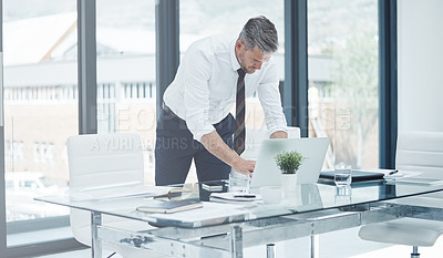 Buy stock photo Shot of a corporate businessman working in an office