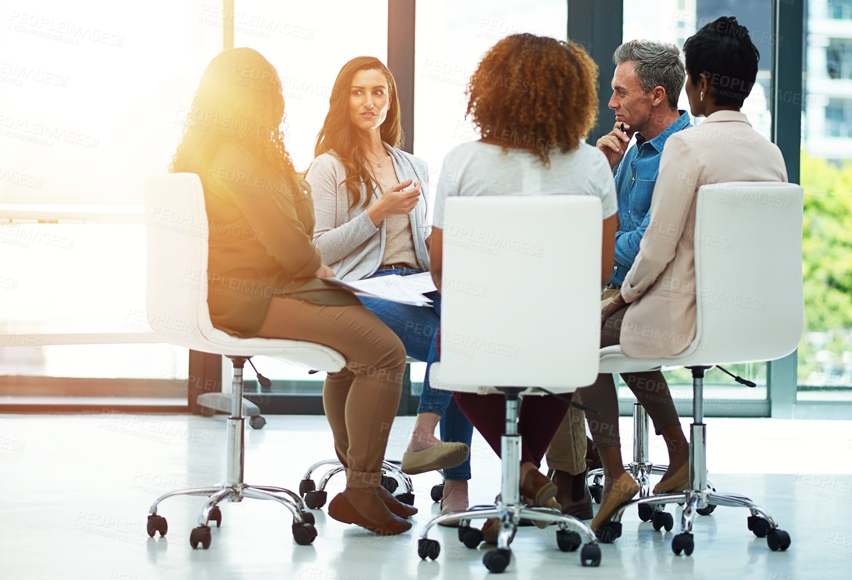 Buy stock photo Shot of a team of colleagues having a meeting in a modern office