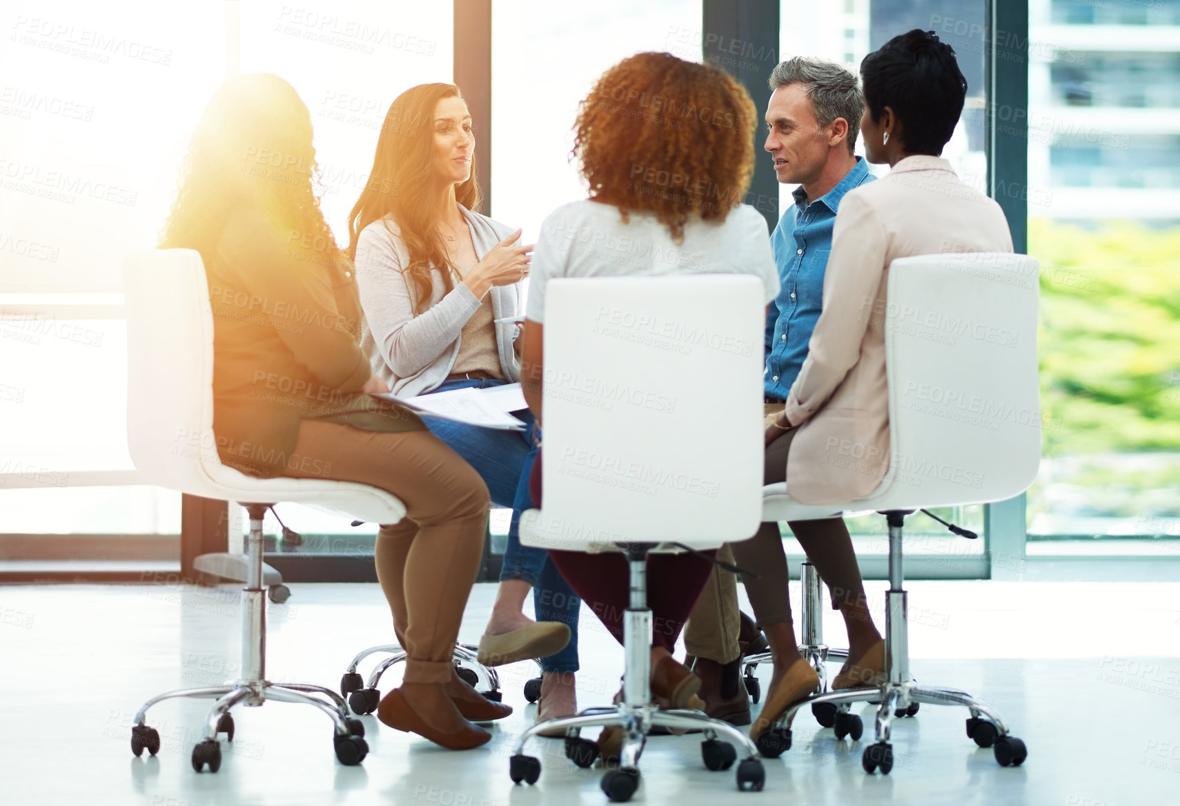 Buy stock photo Shot of a team of colleagues having a meeting in a modern office