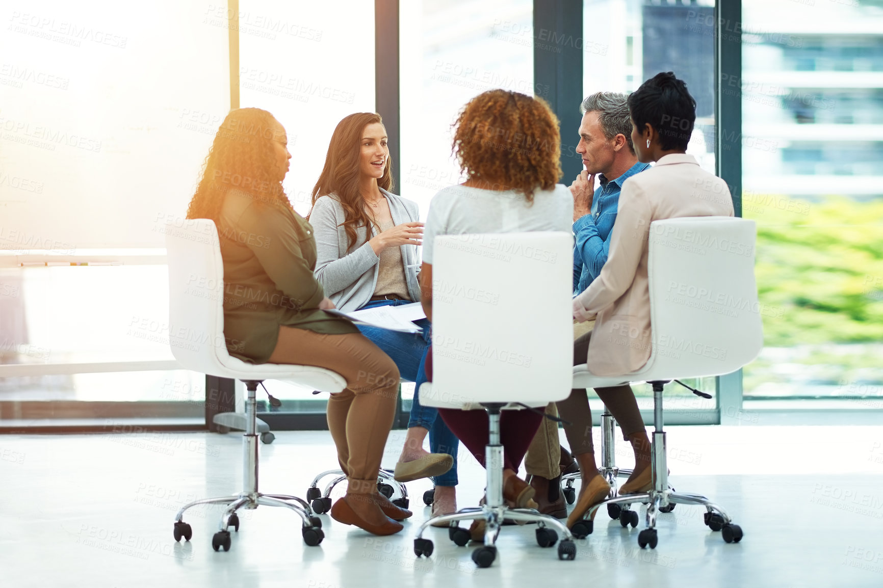 Buy stock photo Shot of a team of colleagues having a meeting in a modern office