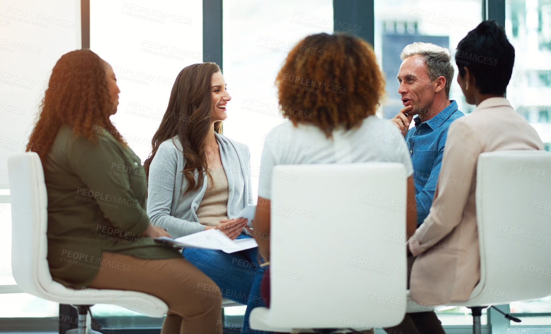 Buy stock photo Shot of a team of colleagues having a meeting in a modern office