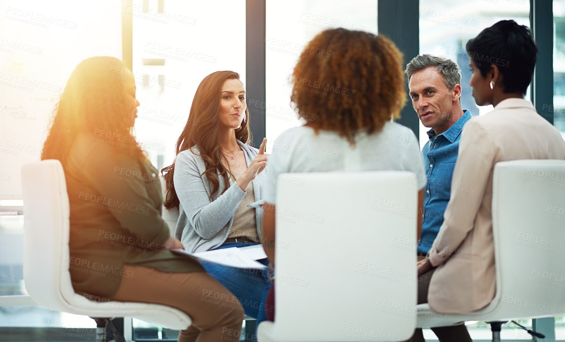 Buy stock photo Shot of a team of colleagues having a meeting in a modern office