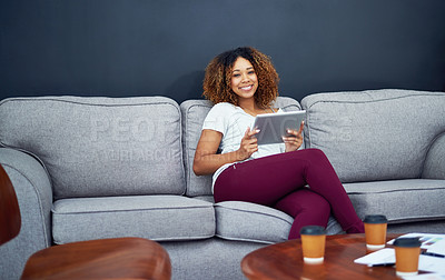 Buy stock photo Portrait of a young businesswoman using a digital tablet on the sofa in a modern office